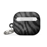 A black wireless earbud case with a silver keyring attached. The Charisma Tiger Fur for AirPods Gen 3 features a brushed metal texture with wavy dark lines and the words "Statement Cases" printed in white on the front. It also comes with an impact-absorbing material for extra protection.