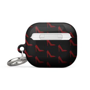 A black Saucy Stillettos for AirPods Gen 3 adorned with a pattern of red high-heeled shoes. It is branded with "Statement Cases" in white text on the front. The impact-absorbing case has a metal carabiner attached to the side for convenience.