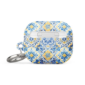 The Blue Mirage for AirPods Gen 3 by Statement Cases is a small rectangular case with rounded edges, adorned with a colorful and intricate tile pattern in blue, yellow, and white. Crafted from impact-absorbing material, the case includes a silver keyring attached to the right side.