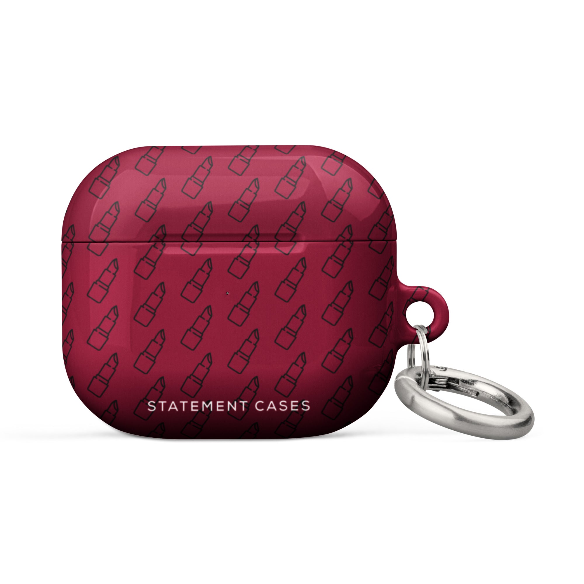 A Rockstar Red for AirPods Gen 3 with a repeating pattern of lipstick icons. The case features an impact-absorbing design and a keychain attachment with a metal carabiner, making it easy to attach to other items. The text "Statement Cases" is written at the bottom front of the case.