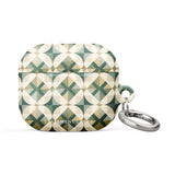 A Grand Estate Mosaic for AirPods Gen 3 with a geometric pattern in shades of green, beige, and white. The pattern features circular designs within square frames. An impact-absorbing material ensures durability while a metal carabiner is attached to the side for convenience. Text on the case reads "Statement Cases.