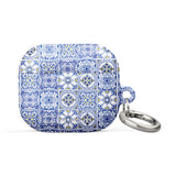 The Lisboa Azul for AirPods Gen 3 by Statement Cases features a rectangular silicon case adorned with a blue and white intricate tile pattern. It comes with a silver metal carabiner on one side, allowing for easy attachment to a bag or keychain, and offers impact-absorbing protection.