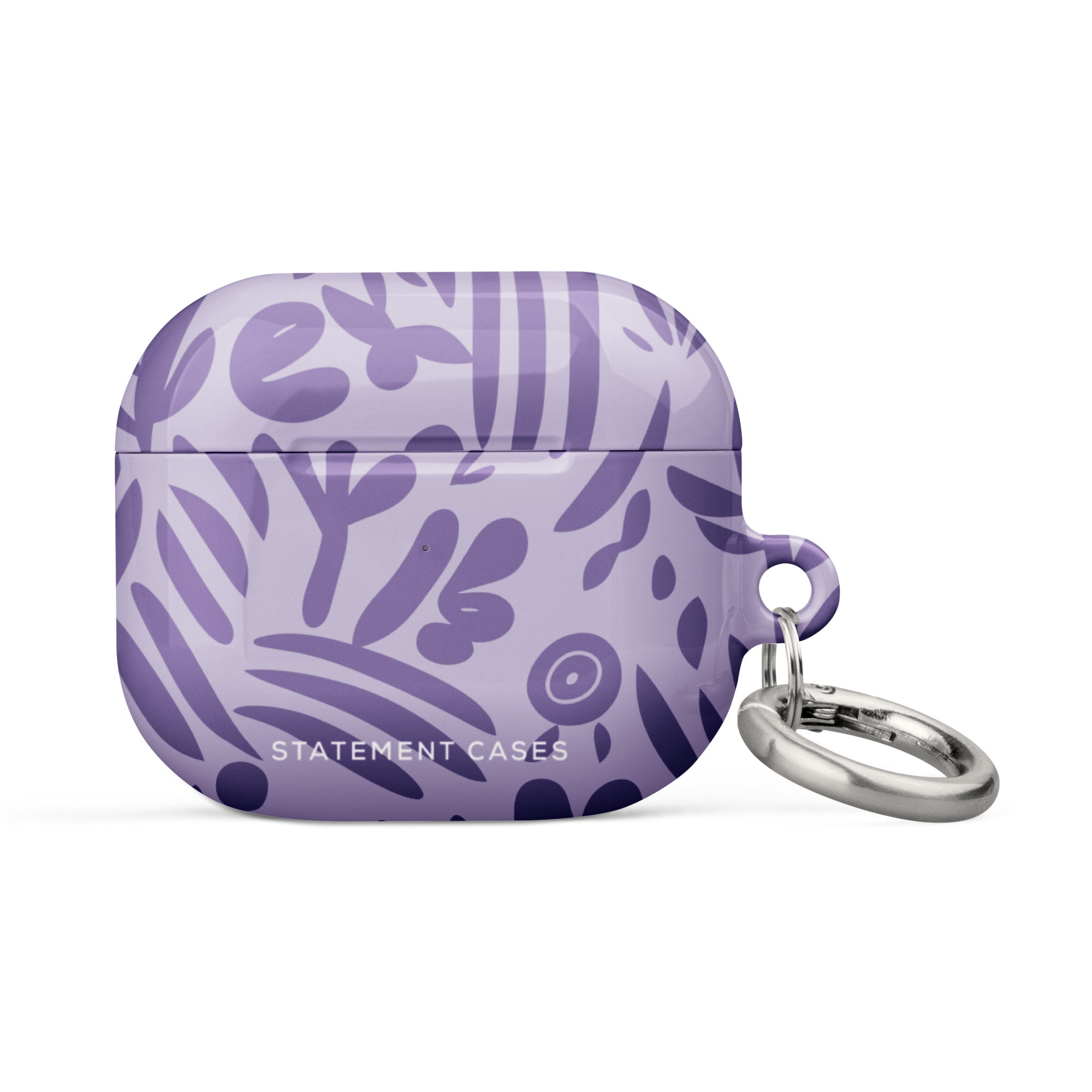 Introducing the Luna Morada for AirPods Gen 3 by Statement Cases—a lavender-colored, impact-absorbing case embellished with abstract dark purple leaf and floral designs. The case includes a silver keyring attached to the right side and displays the brand name "Statement Cases" at the bottom.