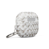 A white protective Chunky Comfort for AirPods Gen 3 by Statement Cases features a textured, knitted pattern design. The case has a small hinge with an impact-absorbing metal carabiner attached, showcasing the brand name "Statement Cases" subtly printed on the front.