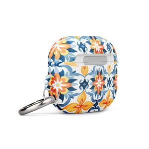 A rectangular AirPods case with a metal carabiner attachment, featuring an impact-absorbing design and a vibrant floral and geometric pattern in blue, orange, yellow, and white colors reminiscent of traditional tile designs. The brand name "Statement Cases" is printed on the bottom. This is the Mediterranean Bloom for AirPods Gen 3.