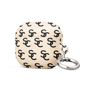 A beige Heritage Monogram for AirPods Gen 3 with a repeating pattern of black interlocking "C" letters, crafted from premium material. It features a small metal carabiner attached to one side and impact-absorbing properties. The words "Statement Cases" are printed at the bottom.