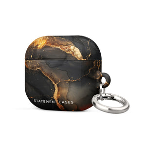 A sleek, black Midnight Volcano Marble for AirPods Gen 3 case with a gold marbling design and a metallic keychain ring attached. Featuring an elegant and artistic appeal, the case also includes a robust metal carabiner for convenience. The bottom boasts "STATEMENT CASES" in white lettering, combining style with impact-absorbing material for added protection by Statement Cases.