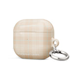 A beige plaid Sophisticated Plaid for AirPods Gen 3 by Statement Cases with a metallic keyring attachment on the right side. Made from premium impact-absorbing material, the case features a light blue and white checkered pattern. The bottom front displays the text "STATEMENT CASES" in white capital letters.