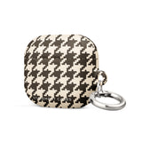 A close-up image of a houndstooth-patterned Timeless Houndstooth for AirPods Gen 3 case with a small keyring attached to its right side. The case features a classic black and white design and has the text "Statement Cases" printed on the bottom. It also includes a durable metal carabiner for secure attachment.