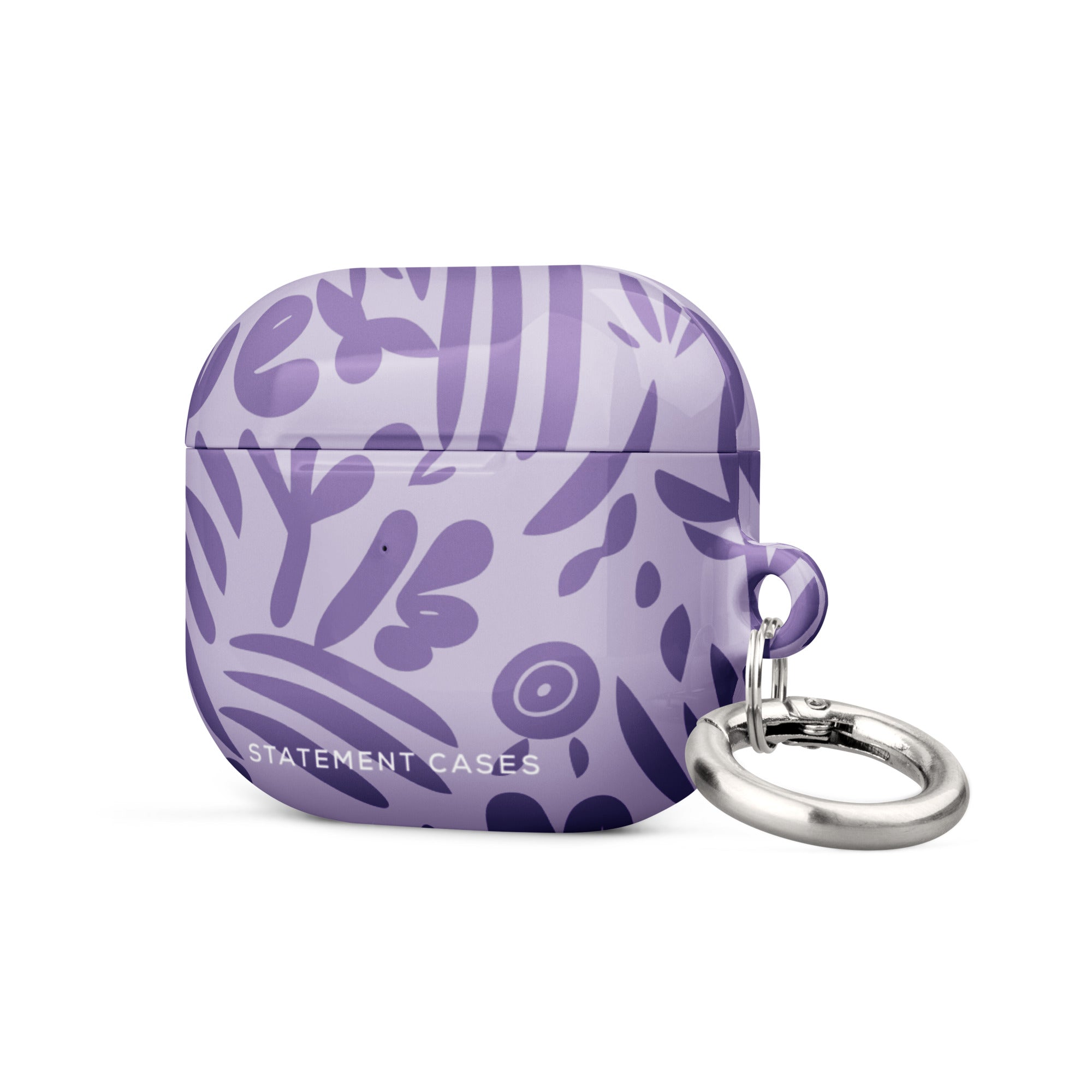 Introducing the Luna Morada for AirPods Gen 3 by Statement Cases—a lavender-colored, impact-absorbing case embellished with abstract dark purple leaf and floral designs. The case includes a silver keyring attached to the right side and displays the brand name "Statement Cases" at the bottom.