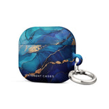 The Midnight Wave Marble for AirPods Gen 3 by Statement Cases is a stylish, impact-absorbing case that features a vibrant blue and gold marbled design with "Statement Cases" printed on the front. It also comes with a sturdy metal carabiner for easy attachment.