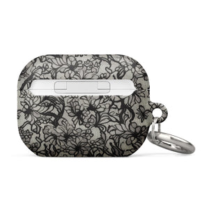 A rectangular Omerta Floral for AirPods Pro Gen 2 case with a black and white lace pattern design. The impact-absorbing case has a metal carabiner attached on the left side, and "Statement Cases" is written at the bottom.