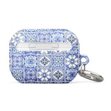 The Lisboa Azul for AirPods Pro Gen 2 by Statement Cases is a rectangular keychain pouch adorned with a blue and white tile pattern, featuring intricate floral and geometric motifs. Enhanced with impact-absorbing material, it doubles as an AirPods case. A metal carabiner is attached to the side for easy attachment to keys or other items.