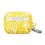 Introducing the Sol Dorado for AirPods Pro Gen 2 from Statement Cases: a yellow AirPods case adorned with a white floral and leaf pattern. This case includes a metal carabiner for easy attachment and is engineered to be impact-absorbing. The brand name "Statement Cases" is printed in small white letters at the bottom center.