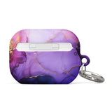 The Golden Orchid Marble for AirPods Pro Gen 2 by Statement Cases features an abstract, swirling pattern in shades of purple and gold, with "STATEMENT CASES" emblazoned on the front. It comes with a metal carabiner for easy carrying and has a premium impact-absorbing design to protect your AirPods.