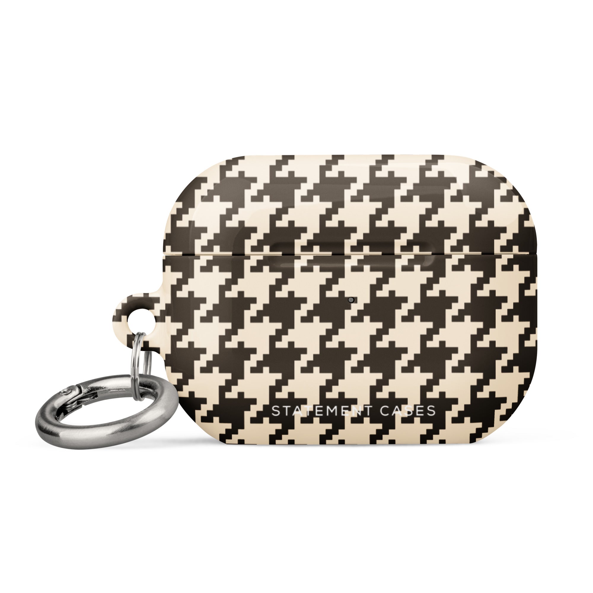 A rectangular Timeless Houndstooth for AirPods Pro Gen 2 with a black and white houndstooth pattern. The case features impact-absorbing material for added protection and has a small metal carabiner attached to the side for easy carrying. The text "Statement Cases" is subtly printed at the bottom center of the case.