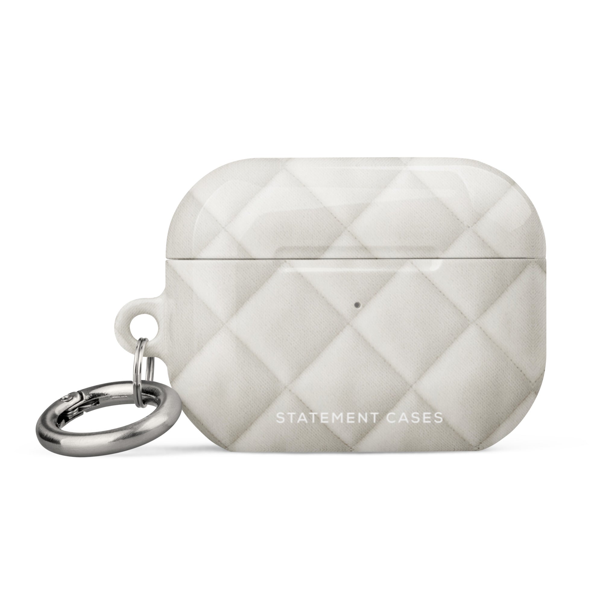 A white, quilted Quilted Delight for AirPods Pro Gen 2 with a silver keyring and metal carabiner attached on the left side. The impact-absorbing material features a diamond pattern and the words "Statement Cases" printed on the bottom front.