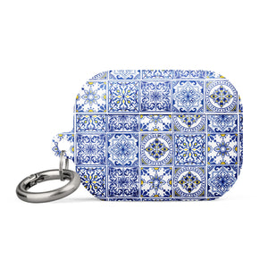 The Lisboa Azul for AirPods Pro Gen 2 by Statement Cases is a rectangular keychain pouch adorned with a blue and white tile pattern, featuring intricate floral and geometric motifs. Enhanced with impact-absorbing material, it doubles as an AirPods case. A metal carabiner is attached to the side for easy attachment to keys or other items.