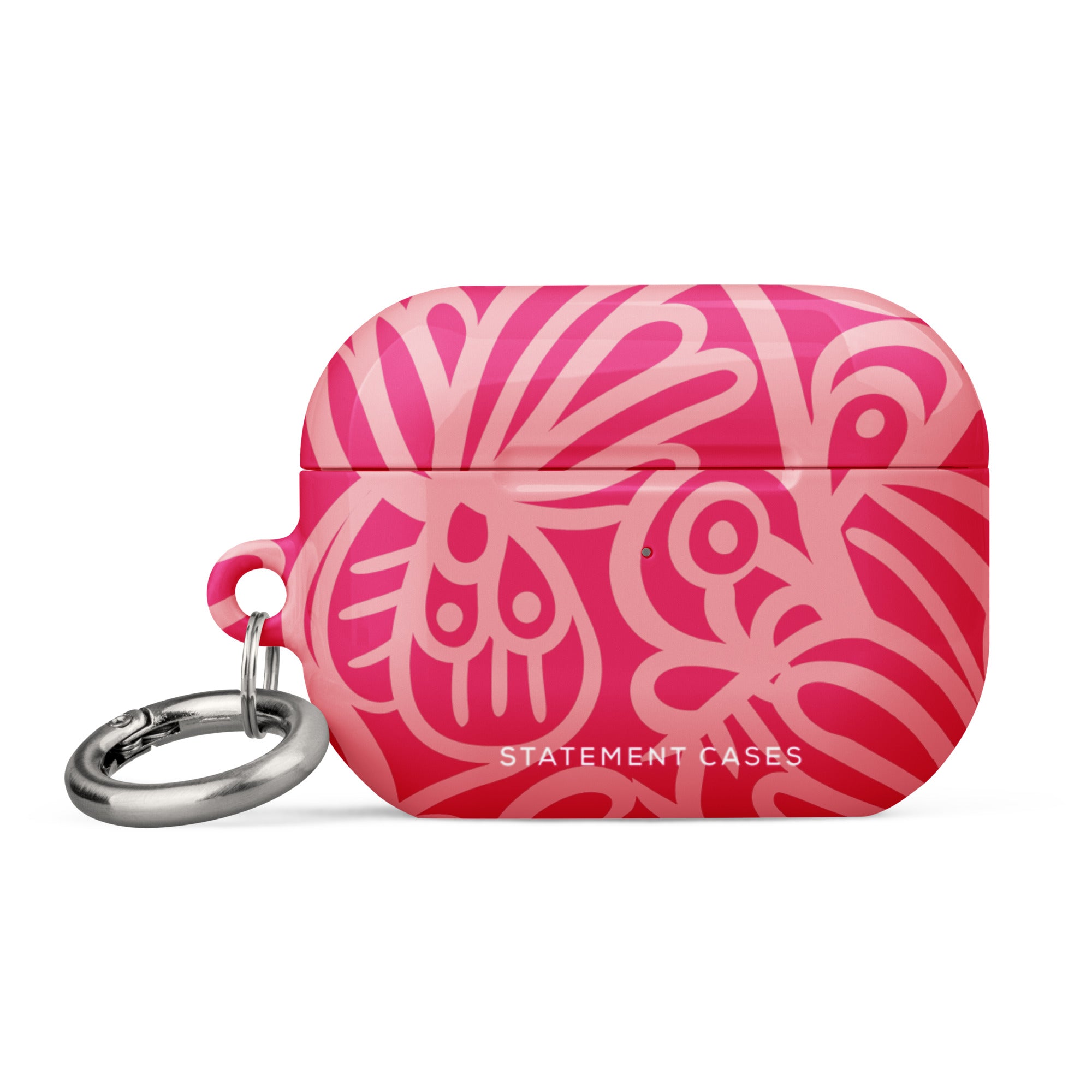 Introducing the Zafiro Rosa for AirPods Pro Gen 2 from Statement Cases, a chic accessory featuring a vibrant, abstract floral design in various shades of pink. The text "STATEMENT CASES" is elegantly printed in white at the bottom, and it comes with an impact-absorbing metal carabiner attached to the left side.