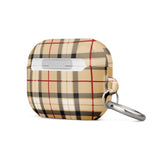 A rectangular beige and brown checkered Neutral Heritage Tartan for AirPods Pro Gen 2 case with an impact-absorbing design and a metal carabiner attached to a corner. The case features the brand name "Statement Cases" printed at the bottom front.