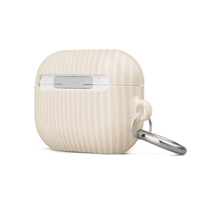 A beige impact-absorbing Noble Pinstripe for AirPods Pro Gen 2 from "Statement Cases" with thin vertical white stripes is shown. The case features a metal carabiner on the left side, making it convenient for attaching to keys or bags.