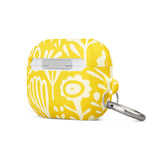 Introducing the Sol Dorado for AirPods Pro Gen 2 from Statement Cases: a yellow AirPods case adorned with a white floral and leaf pattern. This case includes a metal carabiner for easy attachment and is engineered to be impact-absorbing. The brand name "Statement Cases" is printed in small white letters at the bottom center.