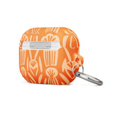 A Savannah Ardiente for AirPods Pro Gen 2 case by Statement Cases, featuring a floral and geometric pattern in lighter orange hues. The phrase "STATEMENT CASES" is printed near the bottom. A metal carabiner is attached to the side of the impact-absorbing case.