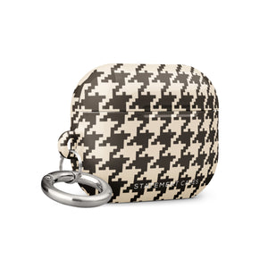 A rectangular Timeless Houndstooth for AirPods Pro Gen 2 with a black and white houndstooth pattern. The case features impact-absorbing material for added protection and has a small metal carabiner attached to the side for easy carrying. The text "Statement Cases" is subtly printed at the bottom center of the case.