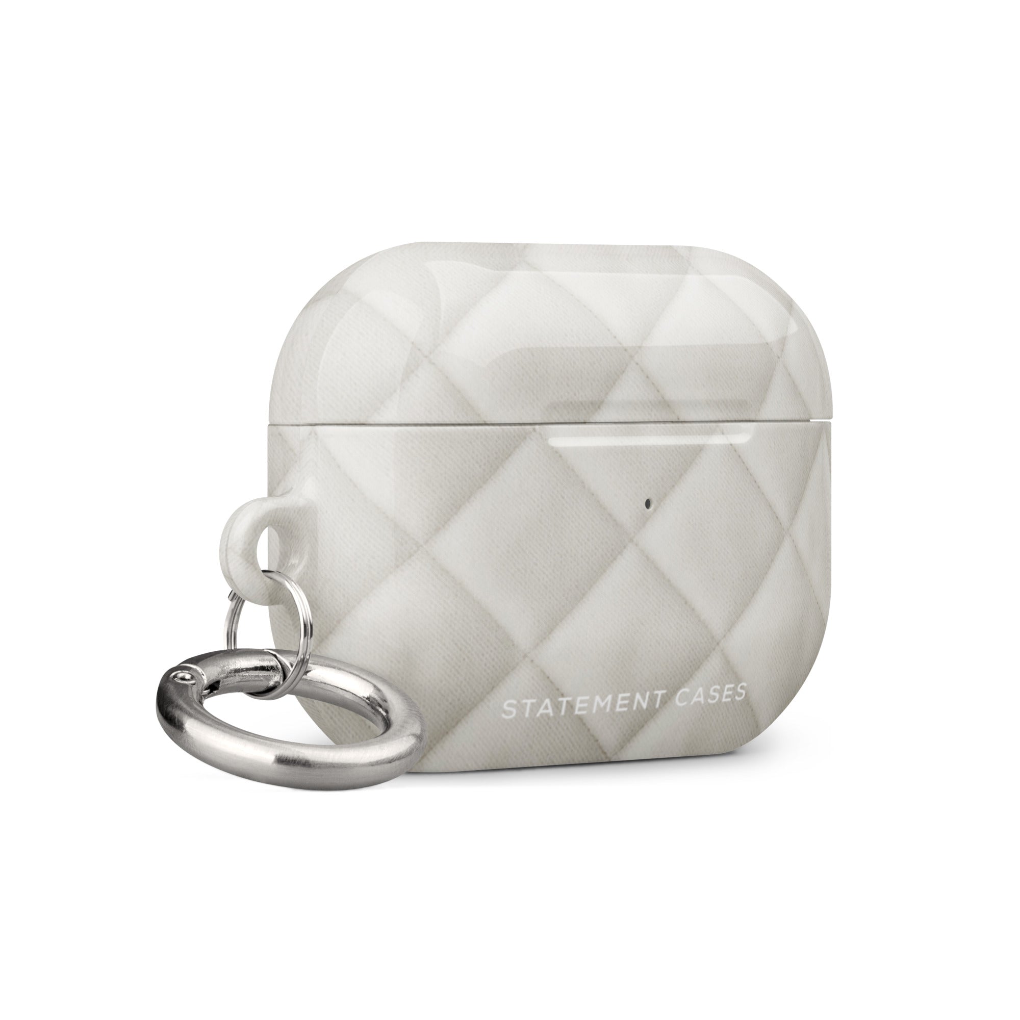 A white, quilted Quilted Delight for AirPods Pro Gen 2 with a silver keyring and metal carabiner attached on the left side. The impact-absorbing material features a diamond pattern and the words "Statement Cases" printed on the bottom front.