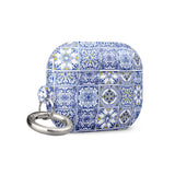 The Lisboa Azul for AirPods Pro Gen 2 by Statement Cases is a rectangular keychain pouch adorned with a blue and white tile pattern, featuring intricate floral and geometric motifs. Enhanced with impact-absorbing material, it doubles as an AirPods case. A metal carabiner is attached to the side for easy attachment to keys or other items.