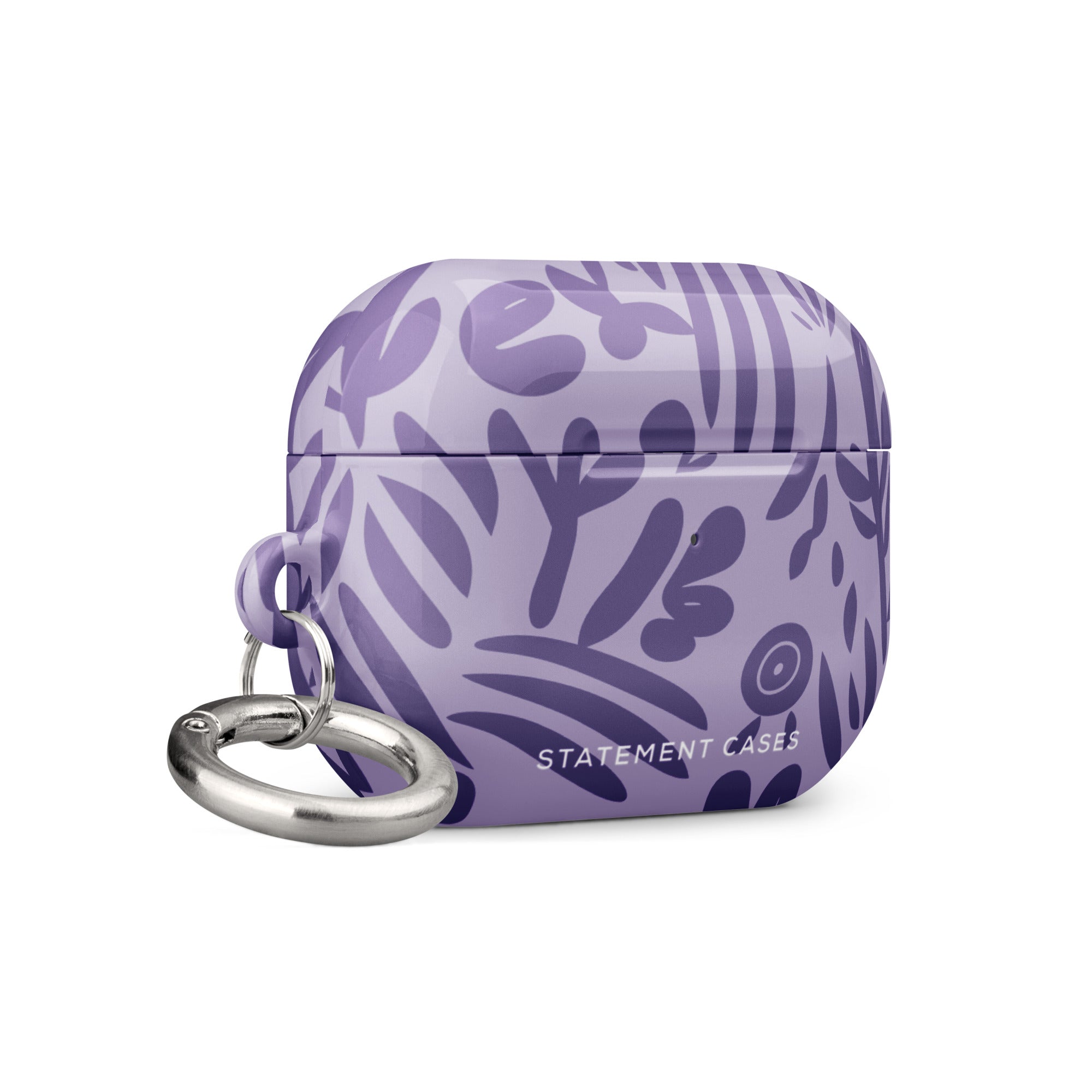 Introducing the Luna Morada for AirPods Pro Gen 2 by Statement Cases, a lavender hard shell case designed for wireless earbuds. Featuring an impact-absorbing property, this case boasts an abstract purple leaf pattern and the "STATEMENT CASES" logo on the front, complete with a metal carabiner for added convenience.