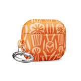 A Savannah Ardiente for AirPods Pro Gen 2 case by Statement Cases, featuring a floral and geometric pattern in lighter orange hues. The phrase "STATEMENT CASES" is printed near the bottom. A metal carabiner is attached to the side of the impact-absorbing case.