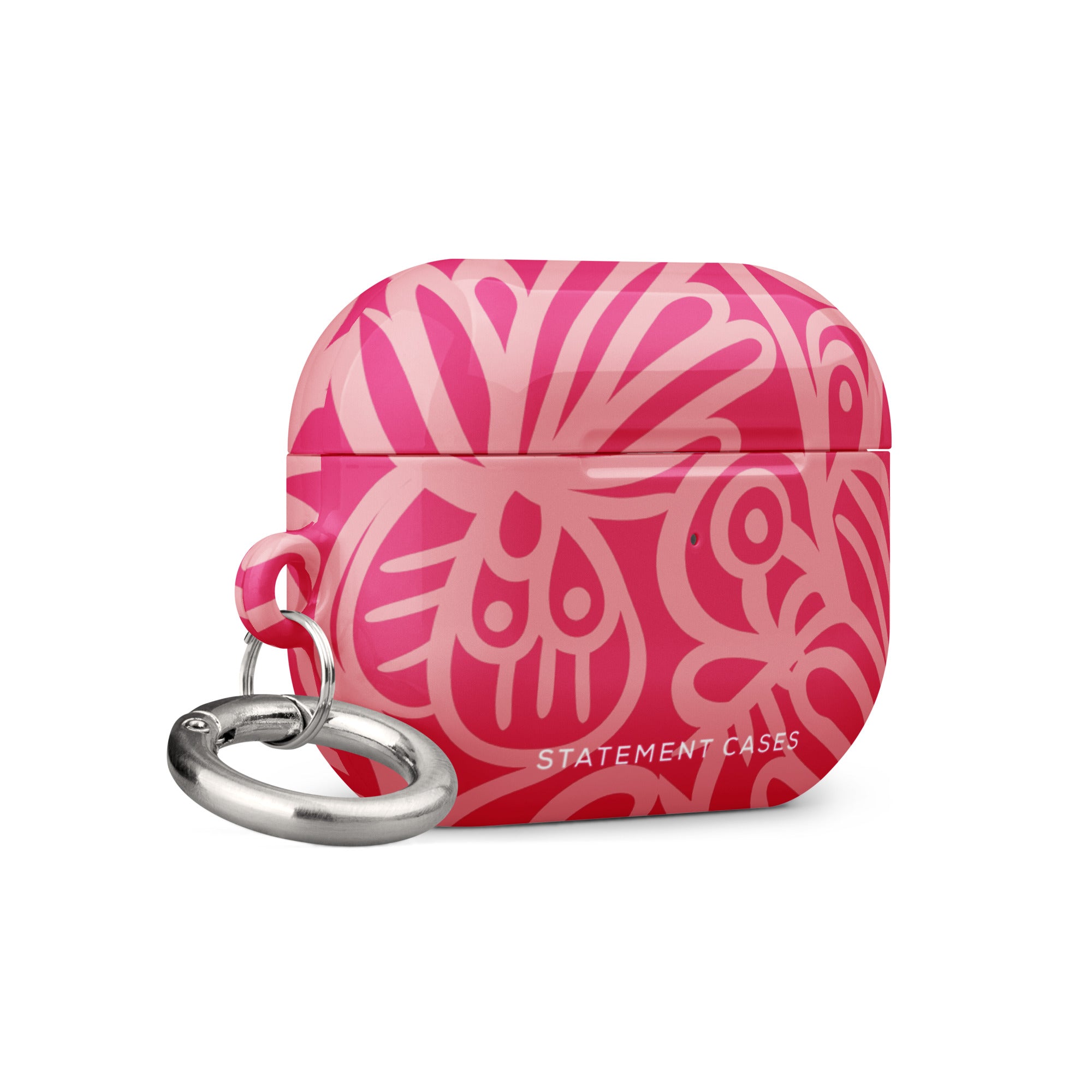 Introducing the Zafiro Rosa for AirPods Pro Gen 2 from Statement Cases, a chic accessory featuring a vibrant, abstract floral design in various shades of pink. The text "STATEMENT CASES" is elegantly printed in white at the bottom, and it comes with an impact-absorbing metal carabiner attached to the left side.