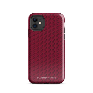 A protective iPhone case with a maroon background and a repeating pattern of small eyeglasses. Designed for the iPhone 15 Pro Max, the camera and buttons of the phone are visible. The bottom of the case features the text "Rockstar Red for iPhone" in white from Statement Cases.