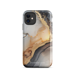 A smartphone with a sleek, marbled design case featuring swirls of gold, beige, and dark grey colors. The camera lenses on the back of the iPhone 15 Pro Max are clearly visible, and the protective Lunar & Gold Marble for iPhone case is branded with "Statement Cases" at the bottom.