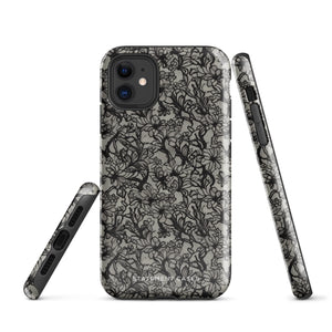 A protective *Omerta Floral for iPhone* case for the iPhone 15 Pro Max, featuring a black cover with an intricate floral lace design. The branding "Statement Cases" is visible at the bottom center, while the phone's camera lenses and flash are prominent at the top left of the case.