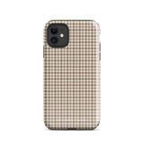 A smartphone with a brown and beige houndstooth-patterned case is shown from the back. The impact-resistant, dual-layered Classic Houndstooth for iPhone by Statement Cases protects the phone's body and leaves openings for the camera lenses and flash. The hues give the case a stylish and sophisticated appearance.