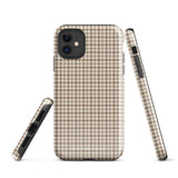 A smartphone with a brown and beige houndstooth-patterned case is shown from the back. The impact-resistant, dual-layered Classic Houndstooth for iPhone by Statement Cases protects the phone's body and leaves openings for the camera lenses and flash. The hues give the case a stylish and sophisticated appearance.