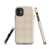 A smartphone with a plaid design case is displayed. The durable phone case features a beige and light brown checked pattern. The phone's camera lenses are visible at the top left corner. With dual-layer protection, the bottom of the impact-resistant polycarbonate Sophisticated Plaid for iPhone case reads "Statement Cases" in white.