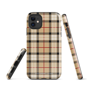 A Neutral Heritage Tartan for iPhone by Statement Cases with a plaid-patterned, impact-resistant polycarbonate case featuring beige, black, white, and red stripes. The durable phone case has the text "STATEMENT CASES" written at the bottom. The phone boasts a triple camera setup with an additional sensor and flash.