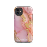 The Gold Blush Marble for iPhone showcases a glossy, marble-patterned case in shades of pink and gold. The decorative design features swirling patterns, seamlessly blending the colors. Crafted with impact-resistant polycarbonate for superior phone protection, "Statement Cases" is written in white at the bottom.