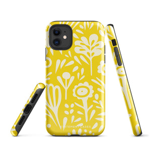 The Sol Dorado for iPhone by Statement Cases is a smartphone with a yellow case featuring a white, abstract floral and plant pattern. The camera lenses are prominent in the top left corner of the device. With dual-layer protection and impact-resistant TPU lining, "Statement Cases" is printed at the bottom of the case.