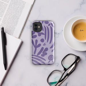 The Luna Morada for iPhone by Statement Cases is a durable phone case with a purple protective exterior featuring abstract dark purple and lavender patterns. The design includes geometric shapes and curves, giving it a modern artistic look. Made from impact-resistant polycarbonate, the lower part of the case prominently displays "STATEMENT CASES.