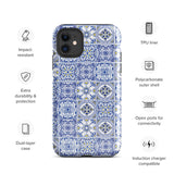 The Lisboa Azul for iPhone by Statement Cases is a smartphone adorned with a dual-layer protection phone case, featuring an intricate blue and white tile pattern. The design showcases various geometric and floral motifs, forming a visually appealing mosaic effect. The impact-resistant camera lenses and flash are prominently visible at the top left.