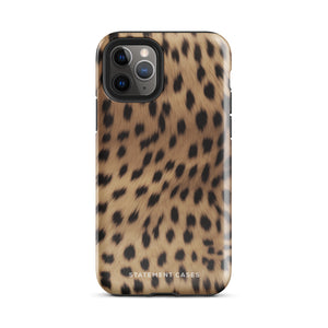 A smartphone with a leopard print case featuring black spots on a beige background is shown. The Daring Cheetah Fur for iPhone, designed for the iPhone 15 Pro Max, is labeled "Statement Cases" near the bottom. The phone's camera lenses and flash are visible at the top left corner.
