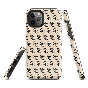 A beige protective iPhone case with an interlocking black "SC" pattern displayed across its back. Custom-tailored for the iPhone 15 Pro Max, the Heritage Monogram for iPhone by Statement Cases features cutouts for the camera lenses and buttons. The design is sleek and minimalistic.