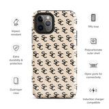 A beige protective iPhone case with an interlocking black "SC" pattern displayed across its back. Custom-tailored for the iPhone 15 Pro Max, the Heritage Monogram for iPhone by Statement Cases features cutouts for the camera lenses and buttons. The design is sleek and minimalistic.