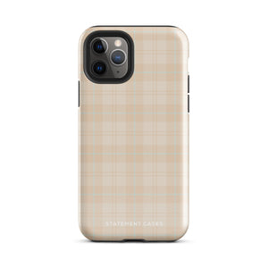 A smartphone with a plaid design case is displayed. The durable phone case features a beige and light brown checked pattern. The phone's camera lenses are visible at the top left corner. With dual-layer protection, the bottom of the impact-resistant polycarbonate Sophisticated Plaid for iPhone case reads "Statement Cases" in white.