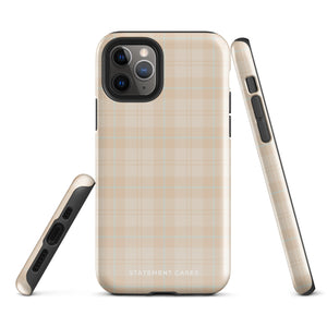 A smartphone with a plaid design case is displayed. The durable phone case features a beige and light brown checked pattern. The phone's camera lenses are visible at the top left corner. With dual-layer protection, the bottom of the impact-resistant polycarbonate Sophisticated Plaid for iPhone case reads "Statement Cases" in white.