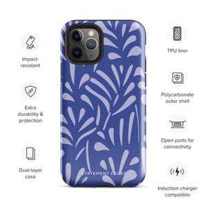 An iPhone encased in the "Mariposa Azul" by Statement Cases, featuring a blue design with an abstract white leaf pattern. The case combines curved and pointed shapes and provides dual-layer protection with TPU lining and impact-resistant polycarbonate. Camera lenses and other top elements remain unobstructed, and "Statement Cases" is inscribed at the bottom.